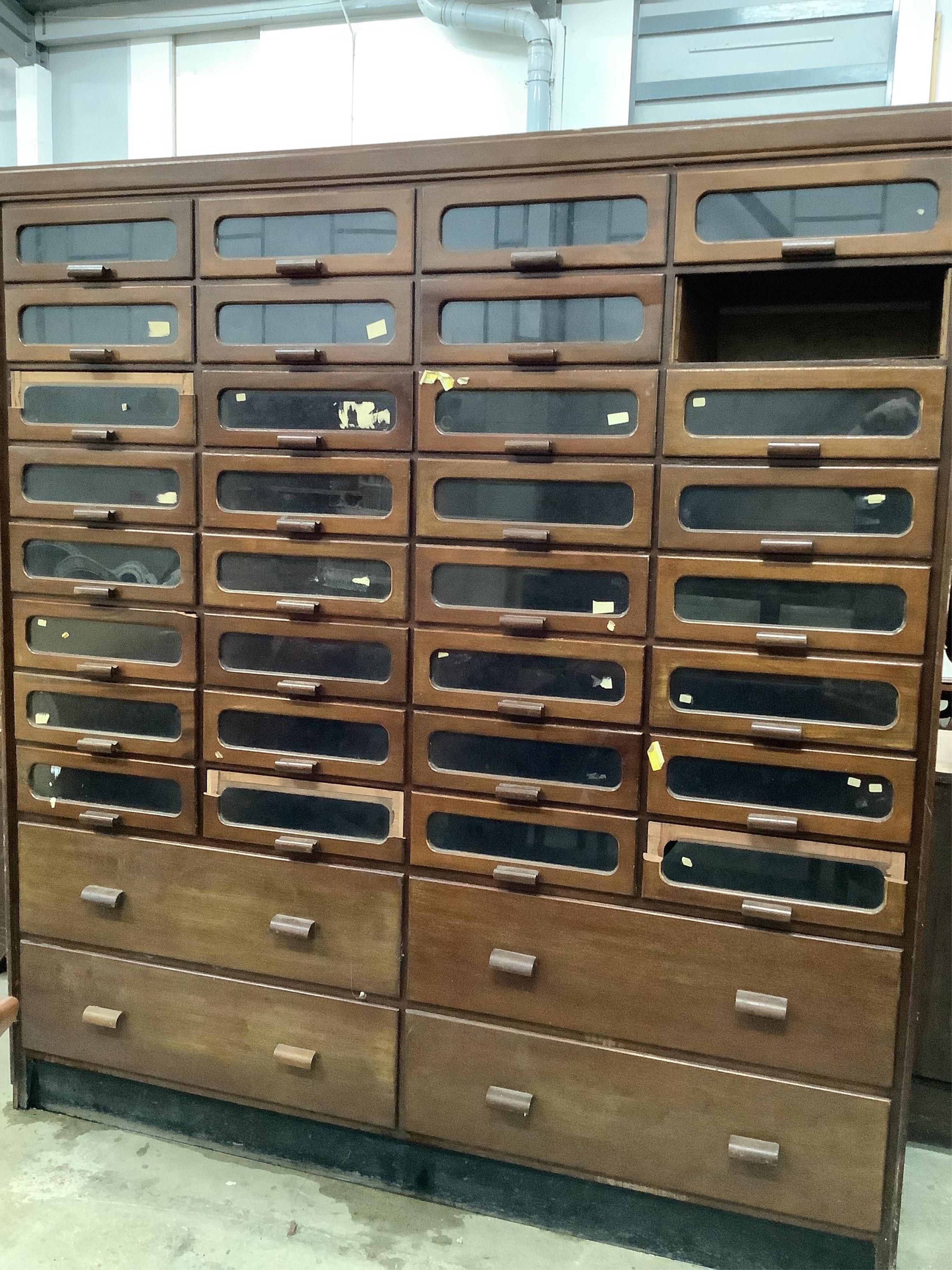 A large mid century mahogany haberdasher's cabinet, width 183cm, depth 50cm, height 199cm. Condition - poor